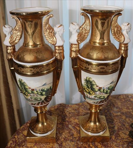Pair of gold painted porcelain mantle vases, 19 in. T.: Pair of gold painted porcelain mantle vases with wing griffins and double handles, 19 in. T, 18 in. W.