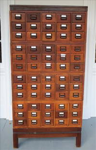 Tall mahogany library card file cabinet with metal pulls: Tall mahogany library card file cabinet with metal pulls and fitted drawers, 6 ft. T, 17 in D, 32 in. W.