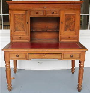 Walnut Victorian plantation desk with lift top: Walnut Victorian plantation desk with burl trim, red leather lift top, turned legs and original wood pulls, ca. 1860, 60 in. T, 54 in. W, 31 in. D.