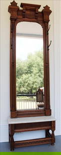 Walnut Victorian pier mirror with original white marble base: Walnut Victorian pier mirror with 4 hat hooks, original white marble base, pierce carving and burl trim, 93 in. T, 29 in. W, 13 in. D.