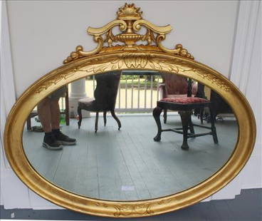 Empire oval wall mirror in gold gilded frame: Empire oval wall mirror in gold gilded frame with good glass, in good condition, 36 in. T, 48 in W.