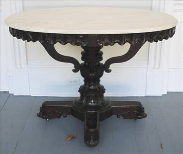 Solid rosewood oval table with marble top and Gothic style: Solid rosewood oval table with marble top and Gothic style, 32 in. T, 45 in. W, 31 in. D.