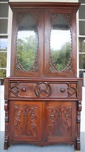2 piece mahogany gothic secretary with fitted interior: 2 piece mahogany gothic secretary with fitted interior and red velvet writing surface, 95 in T, 46 in. W, 23 in. D.