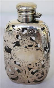 Flask with beautiful sterling-silver overlay: Flask with beautiful sterling-silver overlay, 4 in. T, 3 in. W.