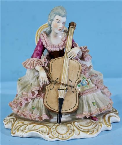 hand painted porcelain Dresden figure of lady playing cello: Dresden hand painted porcelain figurine of lady sitting in a chair playing cello, 7.5 in T, 7 in. W.