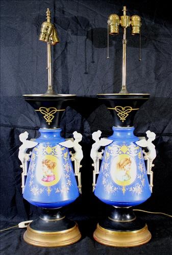 Pair of Old Paris urns made into lamps w figural handles, 32 in. T.: Pair of Old Paris urns made into lamps with princess portraits, gold enamel paint, black and gold base and winged figural handles, 32 in. T, 11 in. W.