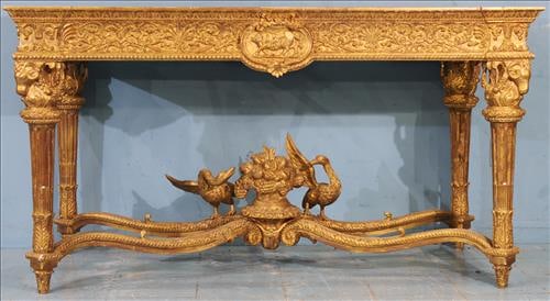 Magnificently carved French gold gilded center table: Magnificent French gold gilded center table, carved all over with various animals, birds and ribbons, unusual base with center medallion. 40 in. T, 71 in. W, 36 in. D.