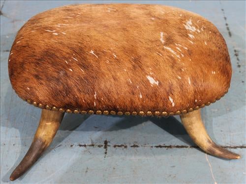 Unique foot stool with cowhide upholstery and horn feet (1 of 3)