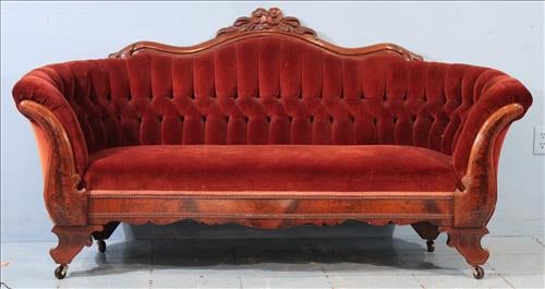 Mahogany empire curved back parlor sofa with crown: Mahogany empire curved back parlor sofa with burnt orange velvet upholstery and carved flowers on crown, 35 in. T, 69 in. W, 12 in. D.