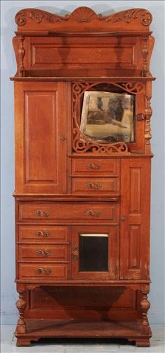 Antique oak dental cabinet with carved crown, mirrored back with metal pulls (1 of 3)