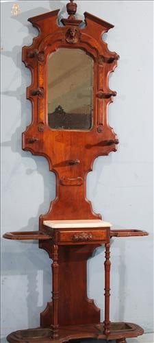 Victorian hall tree, has face on crown, 7 finials and white marble: Victorian hall tree with face on crown, 7 finials, white marble and original metal pans, 78 in. T, 35 in. W, 10 in. D.
