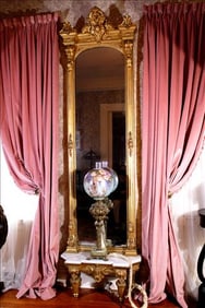 Tall gold gilded pier mirror with Victorian heads and marble base