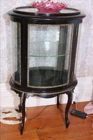 Mahogany curio cabinet with bronze accents and glass shelves