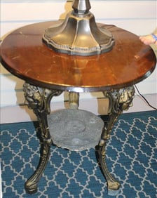 Round antique ice cream table with brass  face on legs, 27 in. T, 22 in. R.