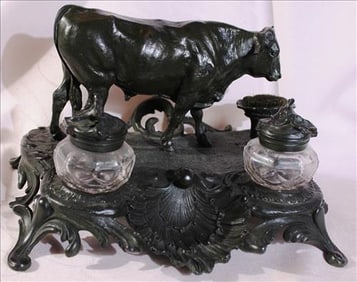 Bronze inkwell in the figure of a black cow, has damage to horn