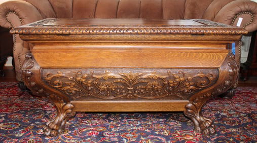 Solid oak carved chest with big claw feet and lift top