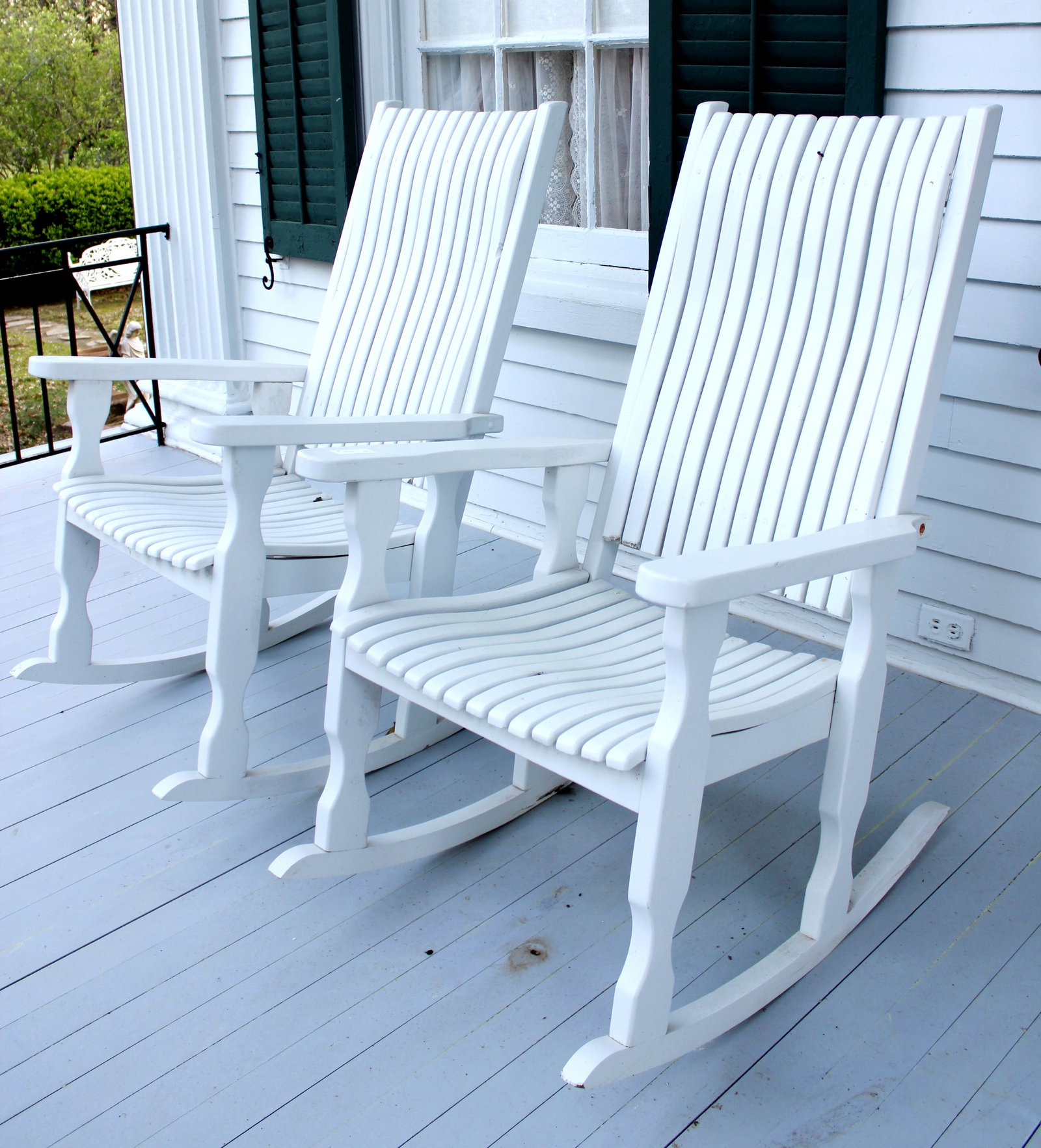 Pair of white wood porch rockers from front porch at Lauri Mundi (1 of 3)