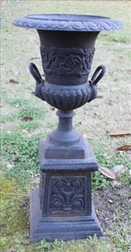 Pair of cast iron garden urns with handles and lions face
