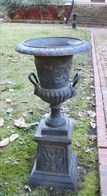 Pair of cast iron garden urns with handles and lions face