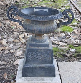 Pair of cast iron garden urns with handles and lions face
