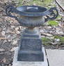 Pair of cast iron garden urns with handles and lions face