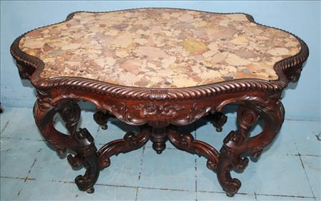 Rosewood heavily carved Meeks parlor table with specimen marble