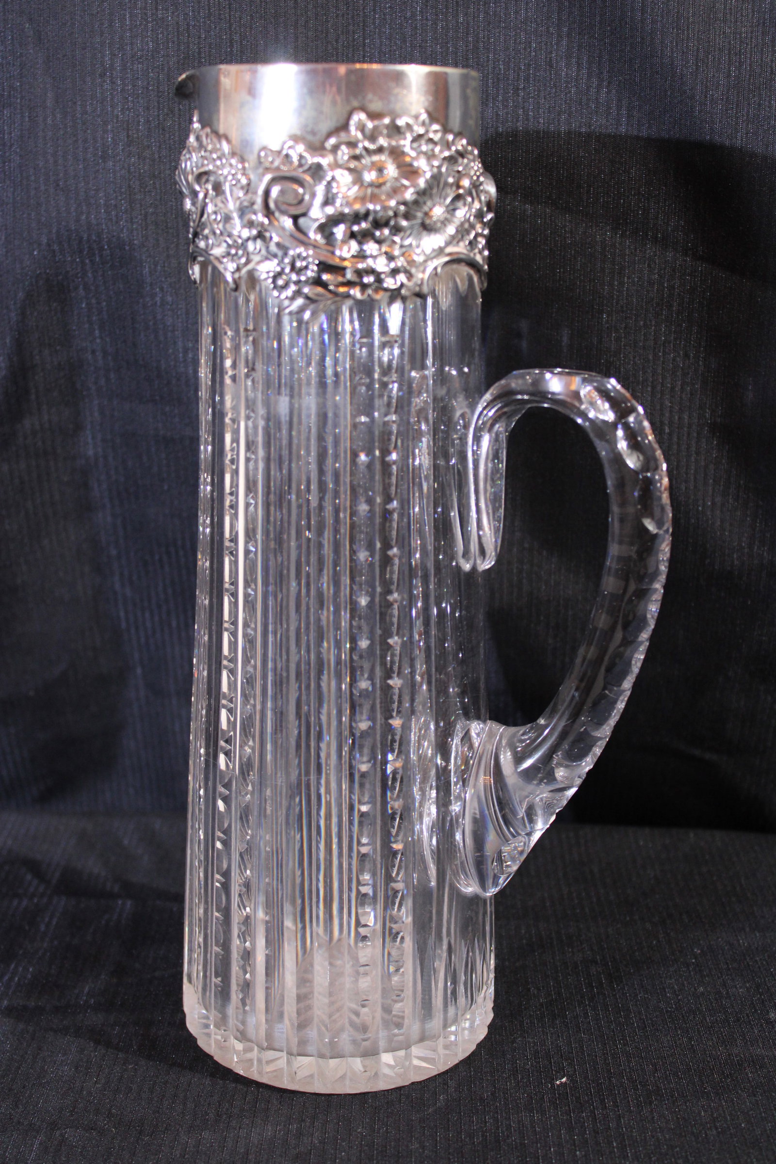 Beautiful zipper cut glass pitcher with applied handle, sterling rim: Beautiful zipper cut glass pitcher with applied handle with sterling rim, 12 in. T, 6 in. W, very old