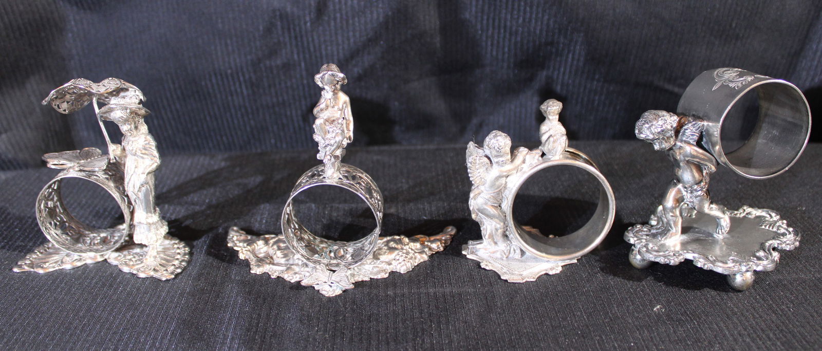 4 Victorian silver-plate napkin rings of people (1 of 4)