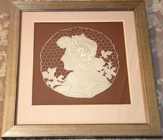 Framed needlework of Victorian lady in metallic frame, 14 in. T, 9 in W.