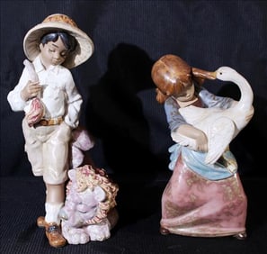 2 Llardo figurines, boy with lion, girl with big goose pulling her hair