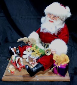 Santa Clause sitting in floor playing with toys, 12 in. T.