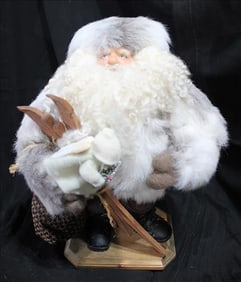 Santa wrapped up going snow skiing with a toy, 18 in. T.