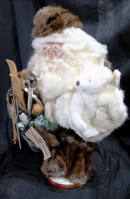 Santa carrying a white bear with fur hat