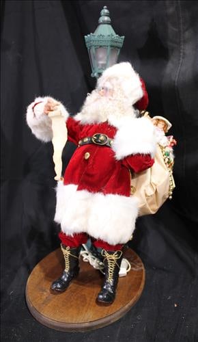 Santa standing out by the lamp post reading his list (1 of 3)