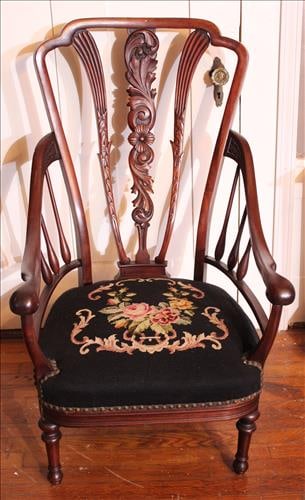 Walnut parlor chair with carved spindle back and needlepoint seat: Walnut parlor chair with carved spindle back and needlepoint seat, 39 in. T, 23 in. W, 20 in. D.
