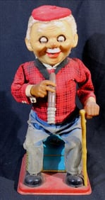 Cigar smoker sits on stand, "Rosko McGregor", with no box