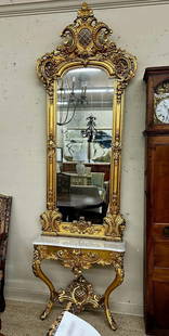 Victorian gold leaf mirror with beautiful ornate crown: Victorian gold leaf mirror with beautiful ornate crown and white marble top, 9 ft. 9 in. T, 32 in. W, 12 in. D.