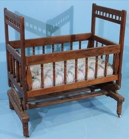 Early wooden rocking crib or craddle with swing lock mechanism and casters, 40 in. T, 27 in. L, 20.5