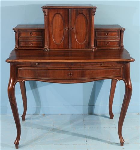 French Louis XV Style Rosewood Ladies Writing Desk: This rosewood writing desk embodies the graceful curves and refined proportions of the Louis XV style. The serpentine top surface is complemented by delicate cabriole legs, while the upper section fea
