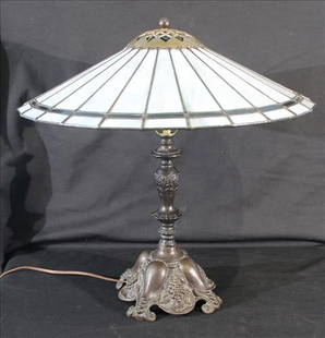 Arts and Crafts Slag Glass Lamp: Arts and Crafts period table lamp, attributed to the Tiffany or Mission Style tradition. Features a paneled slag glass shade in soft white tones with geometric border atop a cast metal base with class