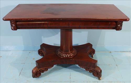 Empire Mahogany Console Table on Carved Pedestal Base: Early-to-mid 19th century Empire mahogany console table with fold-over top and conforming apron. The top pivots and opens to reveal a felt-lined surface. Supported by a robust turned pedestal atop a q