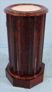 Mahogany Marble Top Drum-Form Half Commode Cabinet: Elegant drum-form cabinet or half commode in a highly polished mahogany veneer. The cylindrical case is paneled and rests on an octagonal plinth base. The side opens to reveal an enclosed interior for