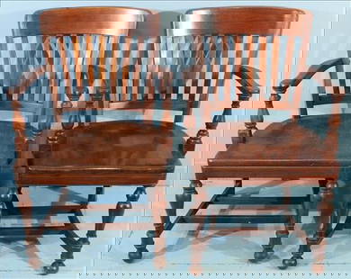 Pair of Vintage Oak Bankers or Courtroom Armchairs: Pair of classic early-to-mid 20th century oak armchairs, often referred to as bankers or courtroom chairs. Each features a curved crest rail, vertical slat back, and shaped plank seat, supported by ro