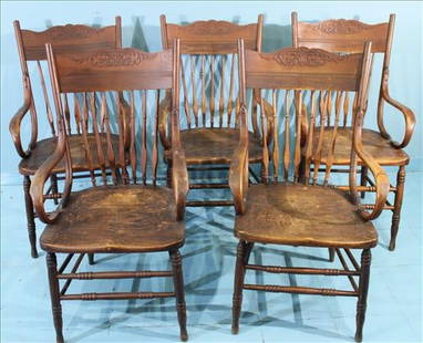 Set of 5 Antique Pressback Dining Chairs with Carved Crests: Set of five late 19th to early 20th century oak pressback dining chairs, including two armchairs and three side chairs. Each features a carved crest rail with foliate motif, turned front legs and stre