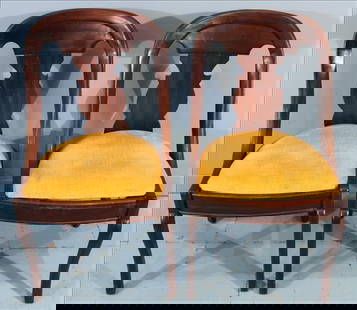Pair of Empire Gondola Side Chairs: Pair of 19th century Empire gondola chairs, each with a sweeping curved crest rail flowing seamlessly into a vase-form splat and elegant saber legs. The gondola form, a variation of the Empire style p