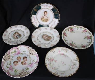 Assorted Lot of Hand-Painted and Transfer Decorated Porcelain Cabinet Plates: Collection of seven Continental porcelain cabinet plates, late 19th to early 20th century, each with unique decoration. Includes: Two plates with romantic cherub scenes, One plate with a portrait of a