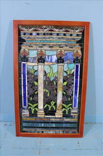 Framed Stained Glass Window Panel with Column and Floral Motif: Colorful stained glass window panel featuring three classical columns flanked by floral motifs, with rich jewel-tone accents in deep blue, ruby, amber, and green. The upper register showcases decorati
