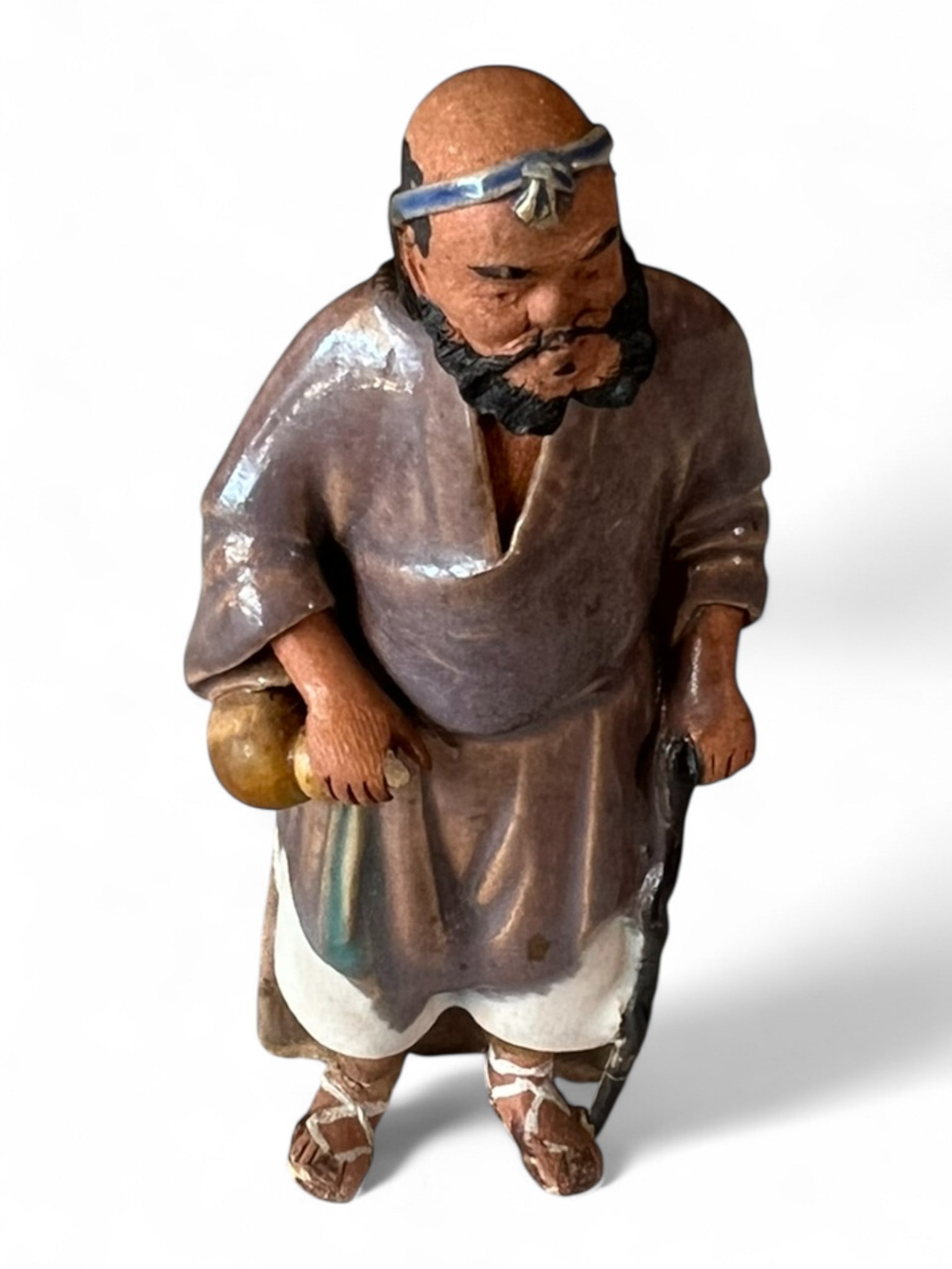 Chinese Glazed Pottery Figure of a Bearded Sage: Chinese pottery figure of a standing sage with double topknots, dressed in a deep brown robe and holding a staff and gourd. Early to mid-20th century. 4 in. H, 1¾ in. W