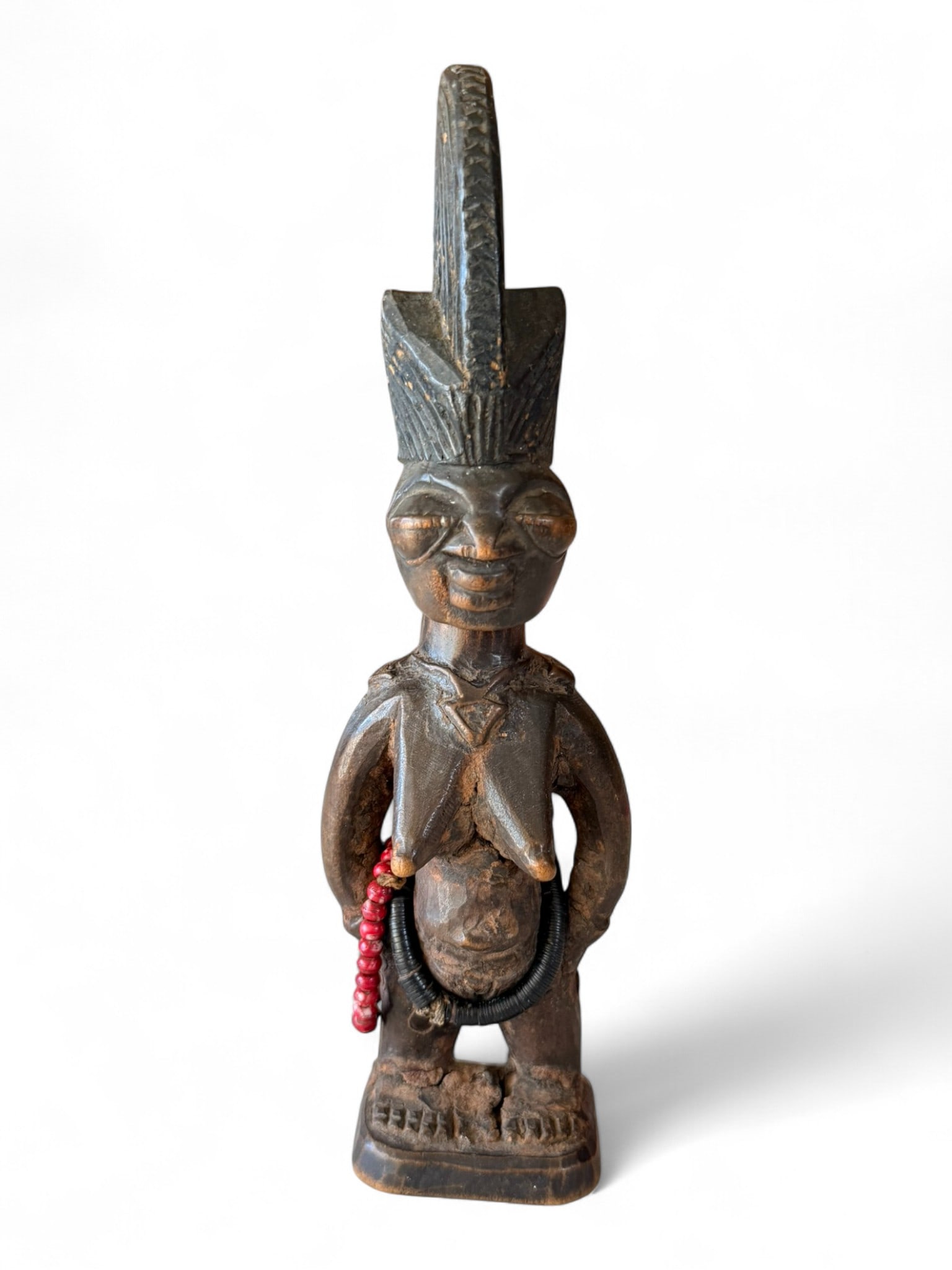 Pair of Yoruba “Ibeji?? Twin Figures, Nigeria, mid-20th century: A fine pair of Yoruba ere ibeji (twin figures) carved in hard brown wood, each depicting a standing male and female figure with elongated headdresses and ornamented with traditional adornments. The ma