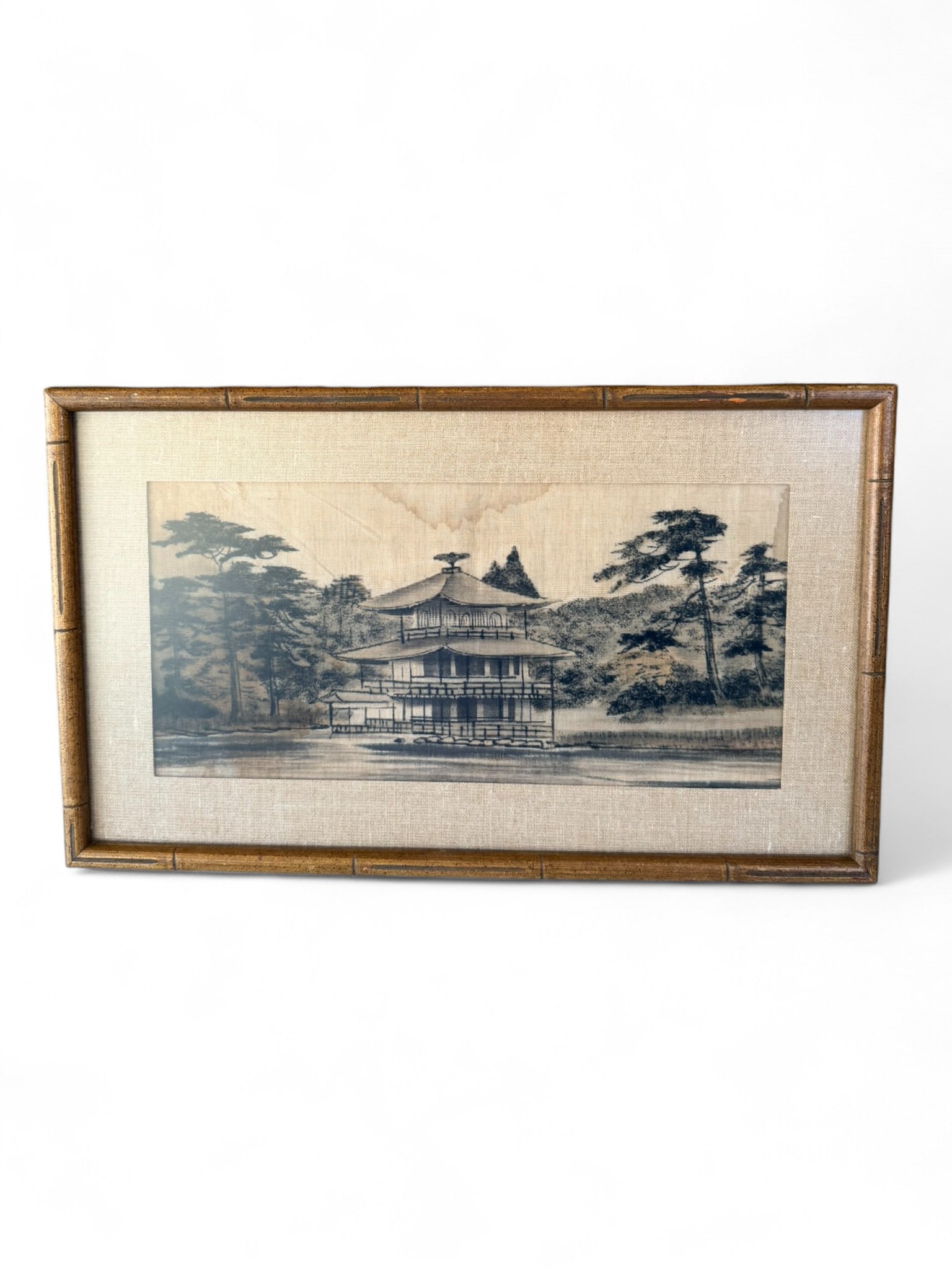 Japanese Architectural Landscape Print, Early–Mid 20th Century: A Japanese monochrome architectural landscape print depicting Kinkaku-ji (the Golden Pavilion) reflected across the pond, rendered in soft grayscale tones on textured fabric backing. Presented in a ba